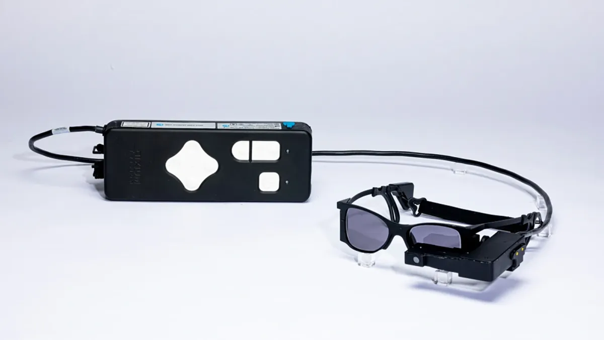 Tiny eye implant, special glasses help some blind patients read