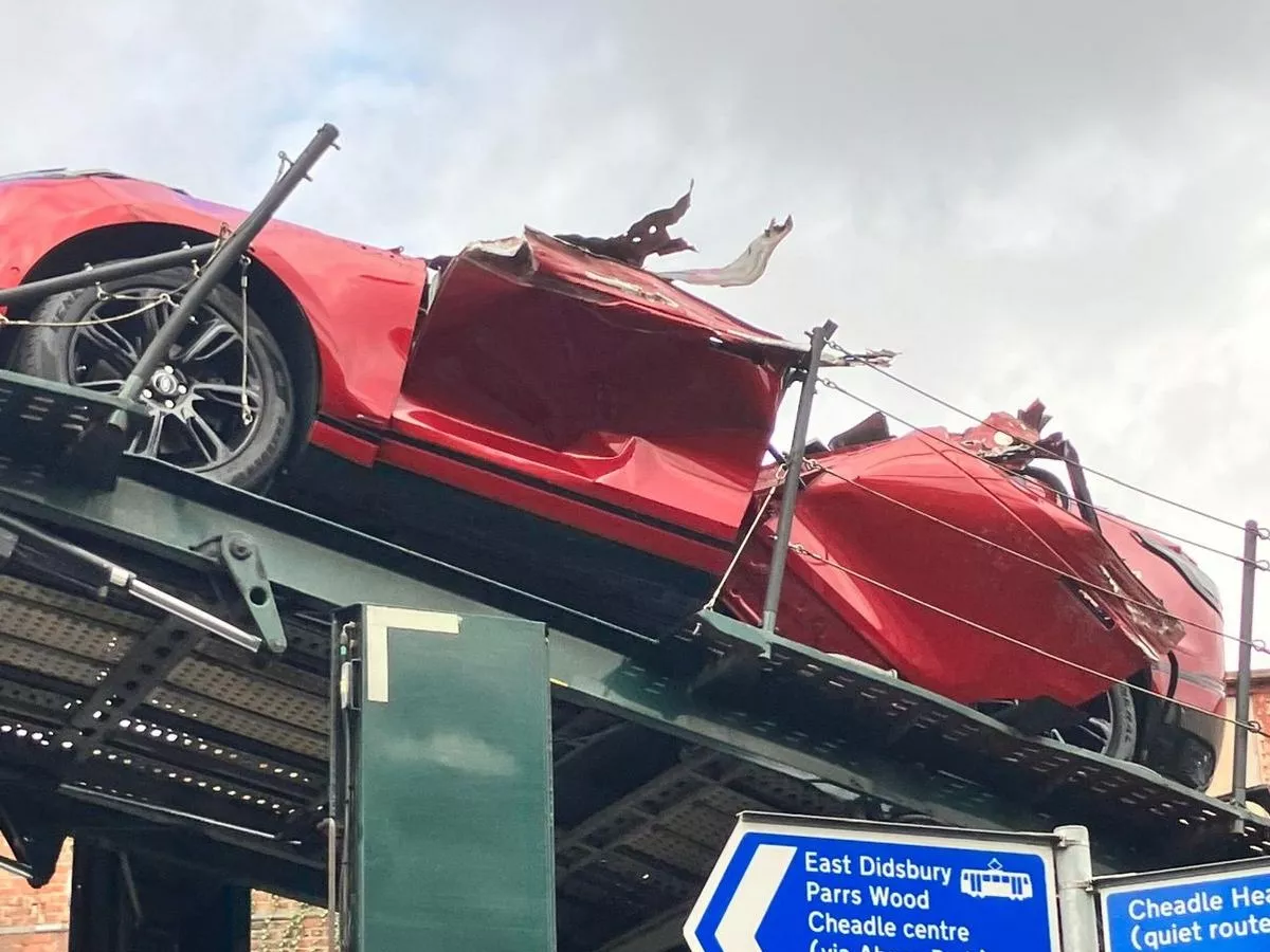 Dramatic pictures show car roof ripped off after vehicle transporter hits bridge
