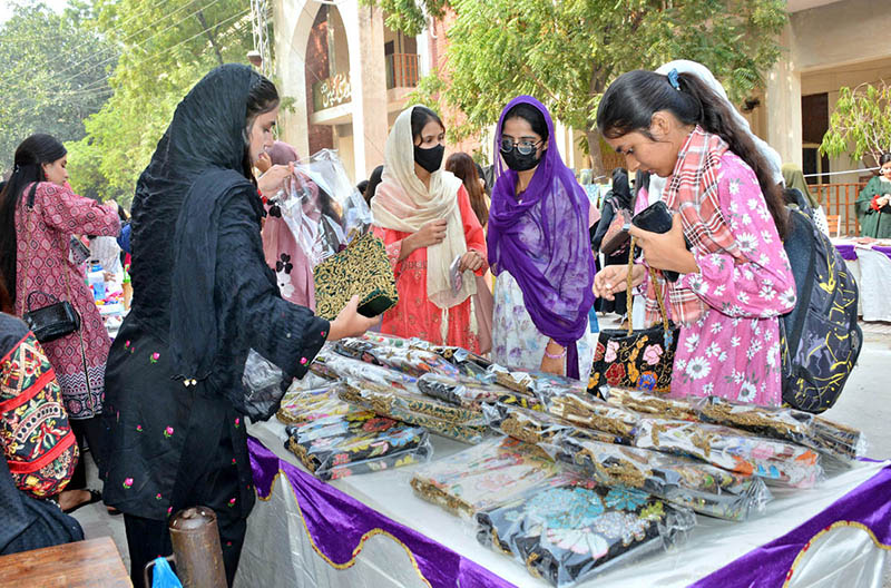 Students take interest in handmade embroidered items displayed at different stalls during the two-day Sports Gala at Women University, Katchery Campus.
