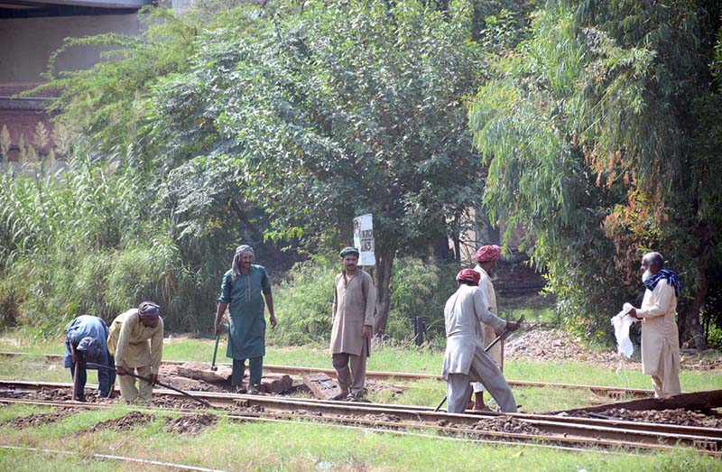 Railways workers busy in work to clear the railway tracks near Railway Station.