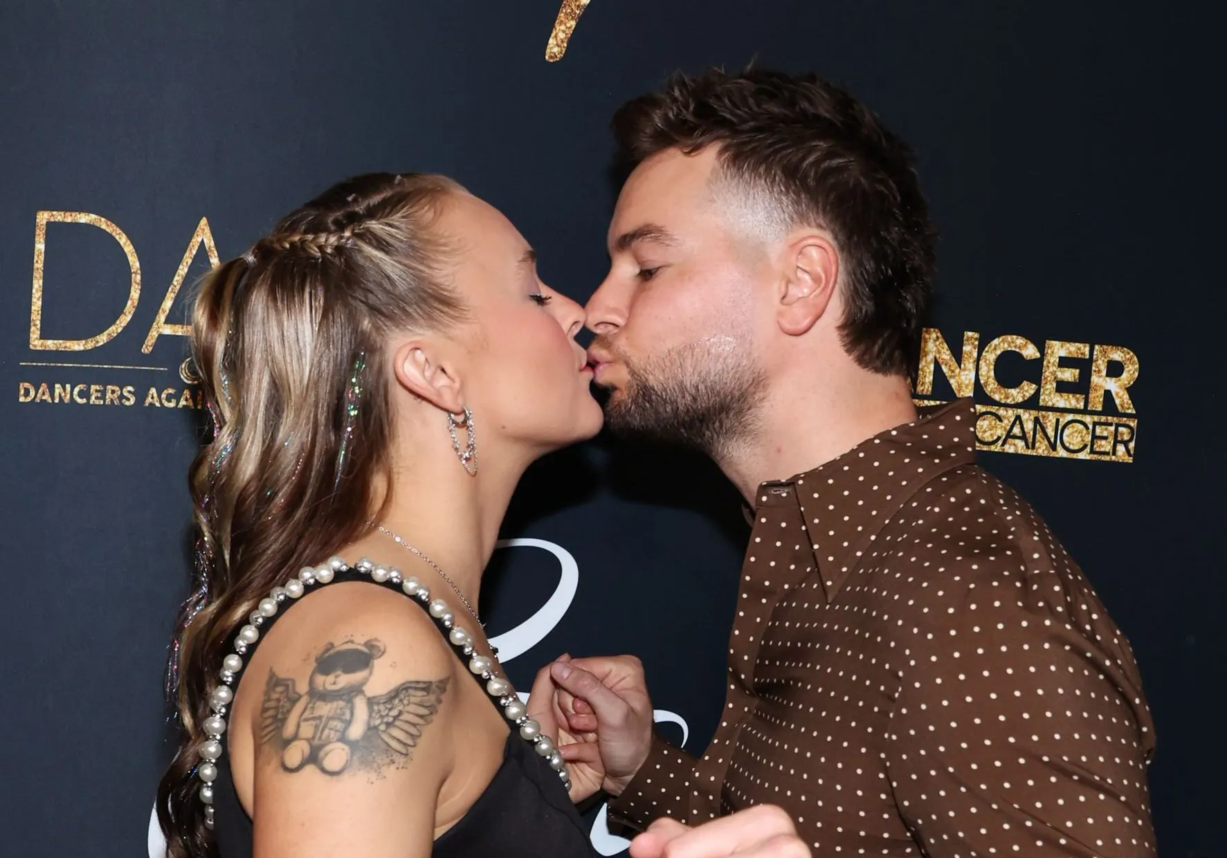 JoJo Siwa and Chris Hughes kiss in red carpet debut before he cries over love for her