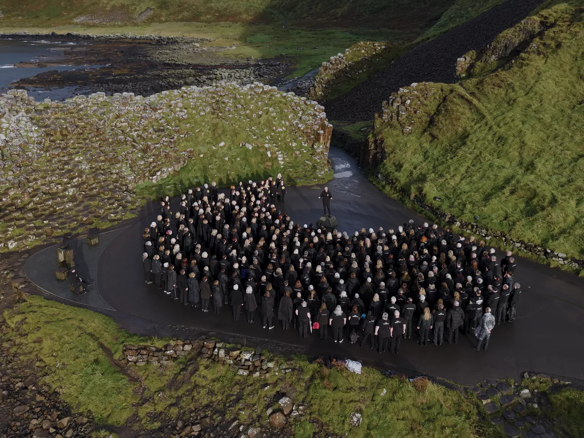 Watch: 500-strong NI Rock Choir celebrates Giant birthday by performing at iconic landmark