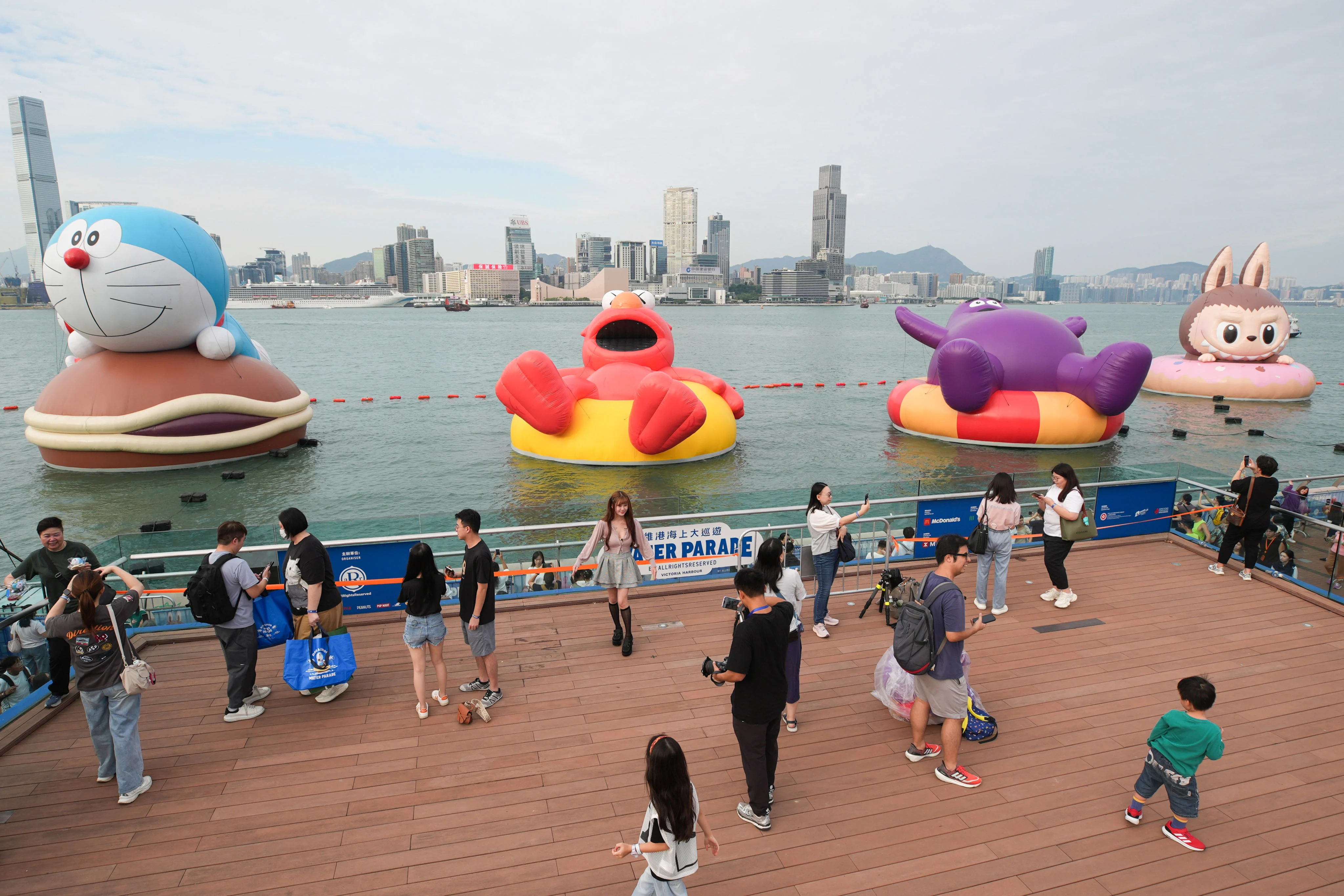 Giant Labubu, Elmo, Grimace and Doraemon floating in Hong Kong harbour