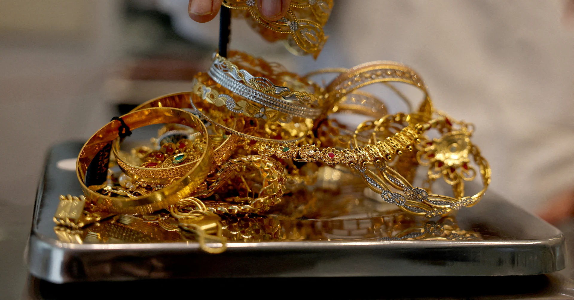 Gold dips on stronger dollar, US-China trade deal hopes