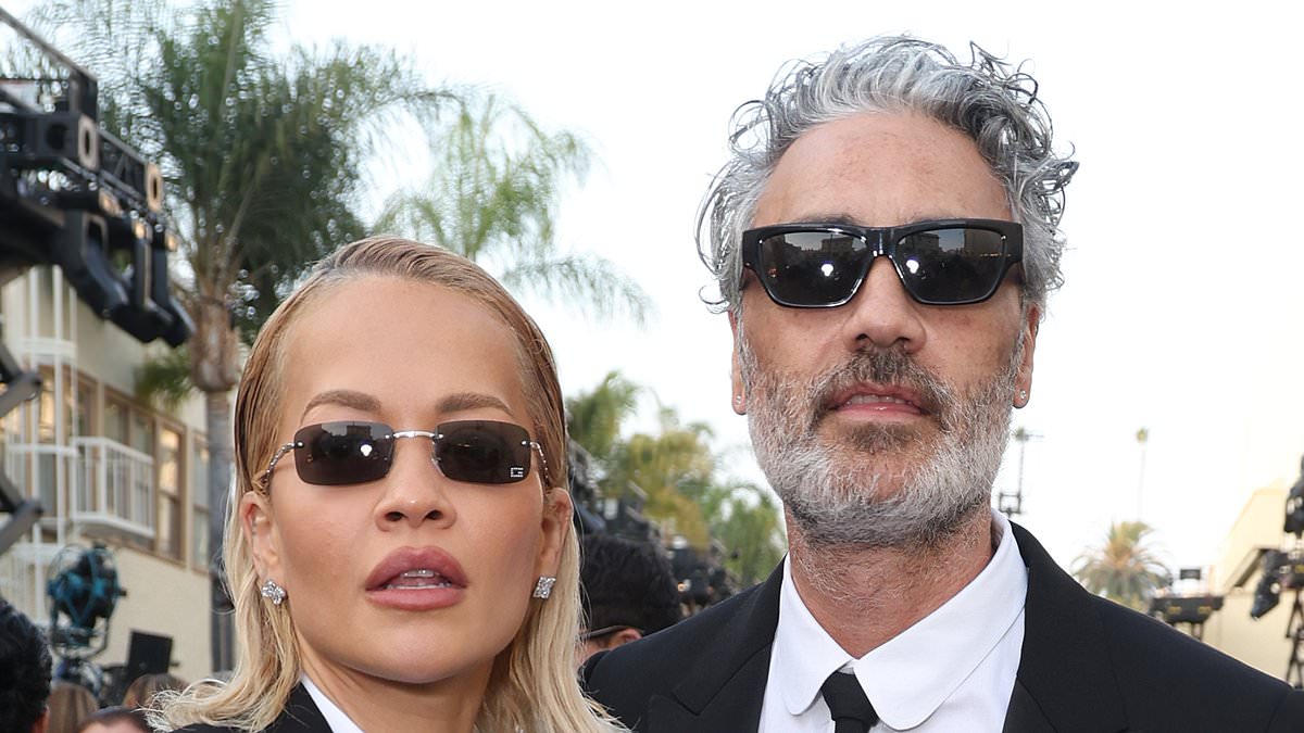 Rita Ora matches her husband Taika Waititi in a chic black trouser suit as they enjoy a date night at the Vogue World: Hollywood show
