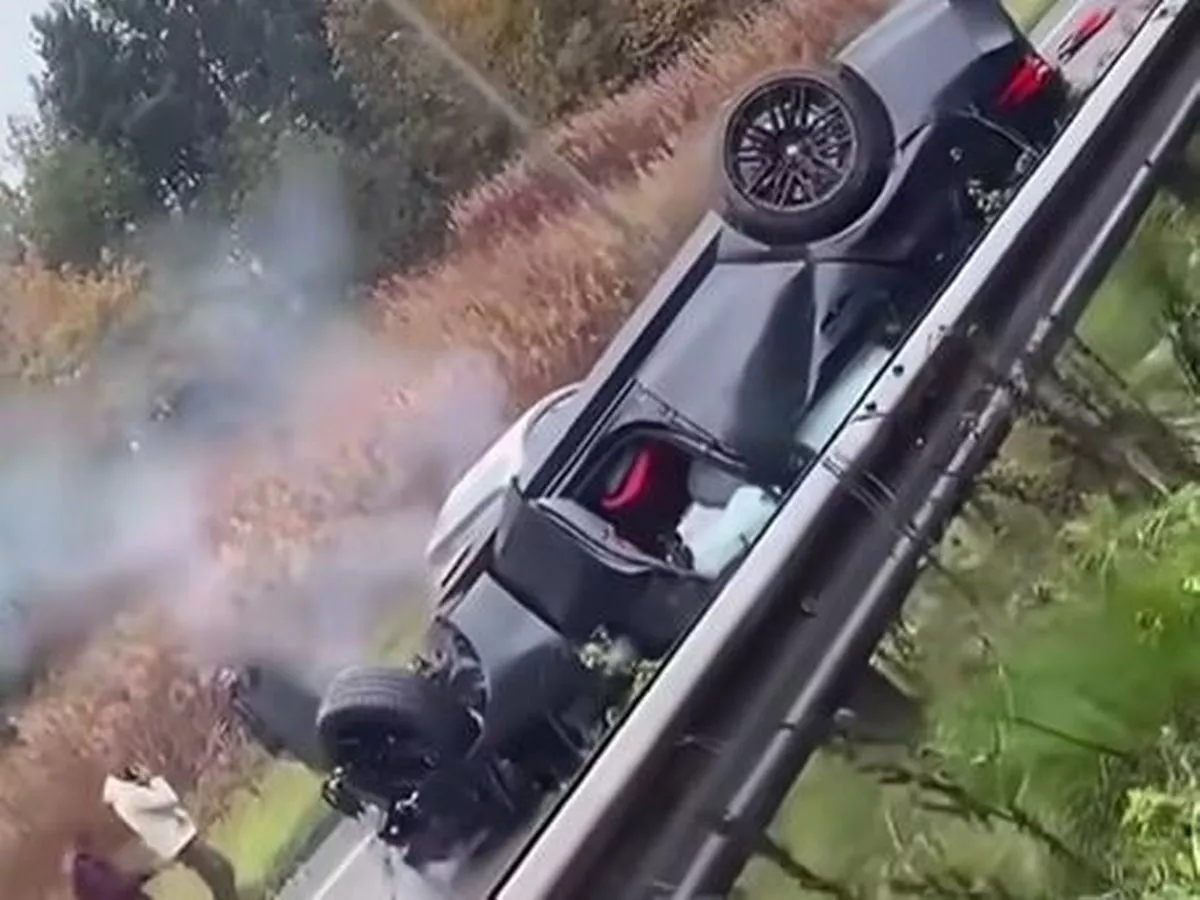 Horror pictures after car is smashed into road sign and flipped onto roof