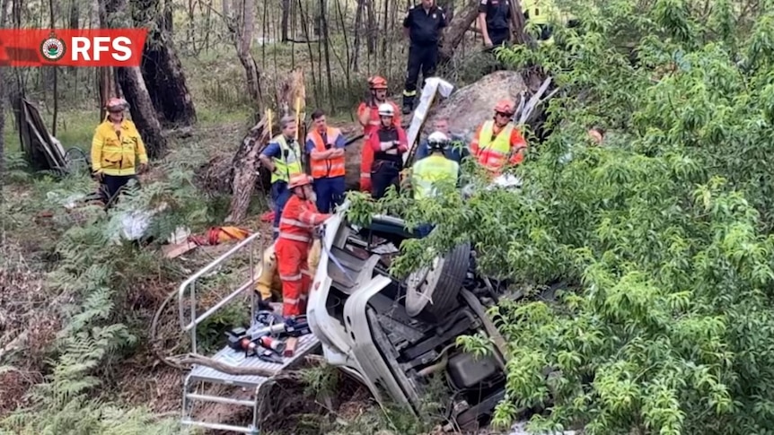 Man stuck in truck rollover spilling rancid fish guts and heads into creek bed