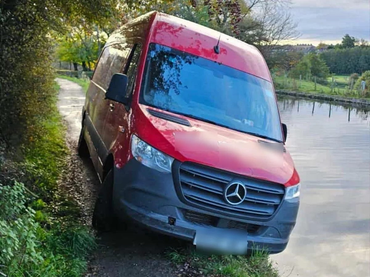 This cannot be real: Courier van seen dumped after being driven down canal towpath