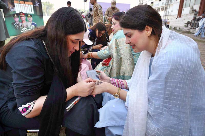 Female participating in mehndi competition during an Event on “Integrated Sports, Theatre, and Arts Activities for Creative Healing and Resilience” organized by The Department of Social Welfare Merged Districts, with the support of UNICEF