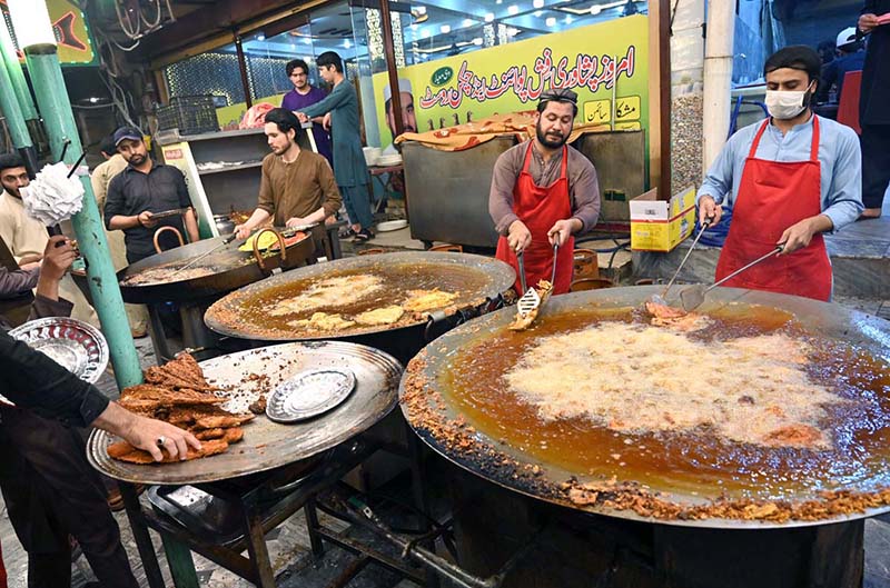 Workers are busy frying fish for customers at 6th Road as demand increases during winter season