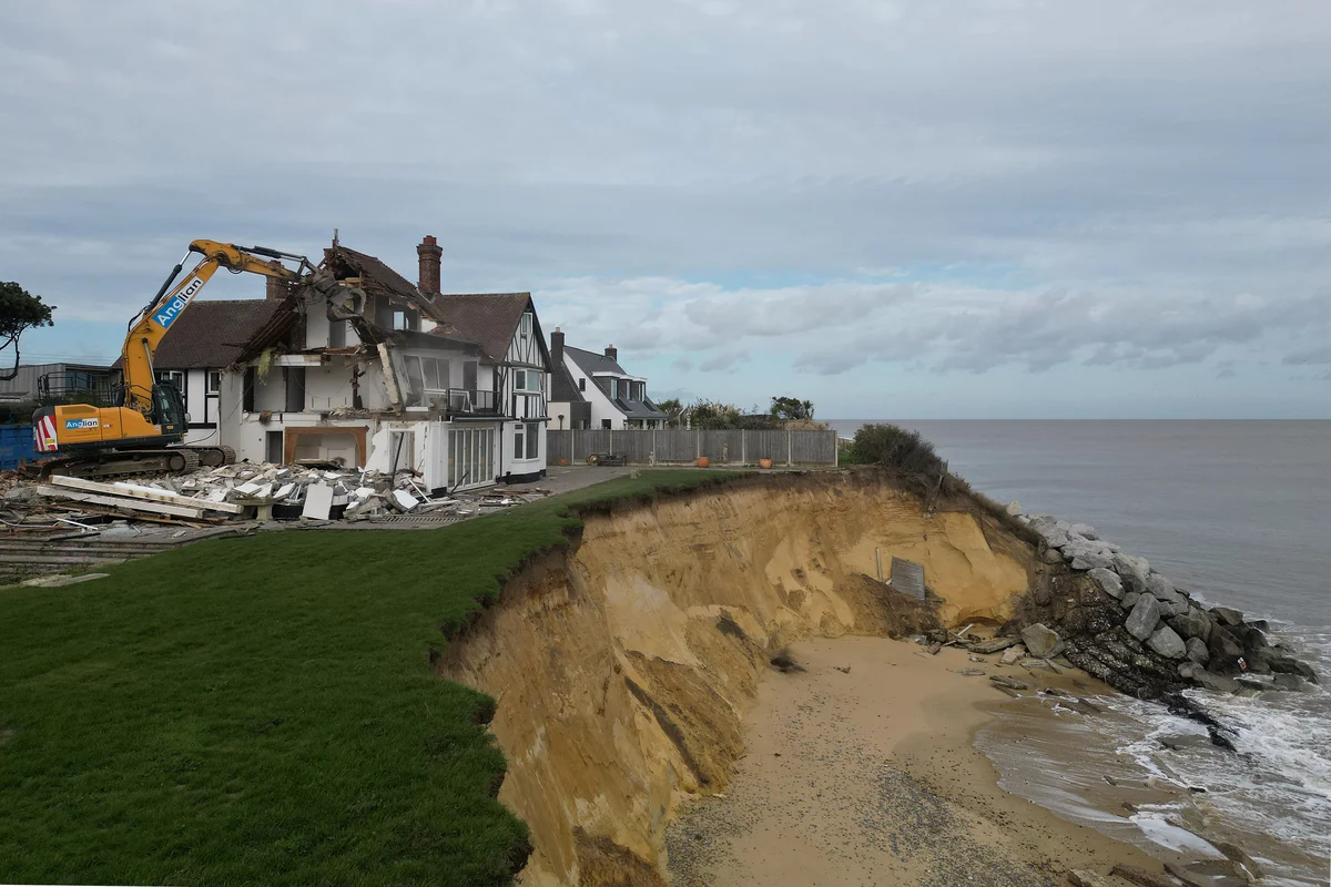 Demolition of clifftop home threatened by coastal erosion under way