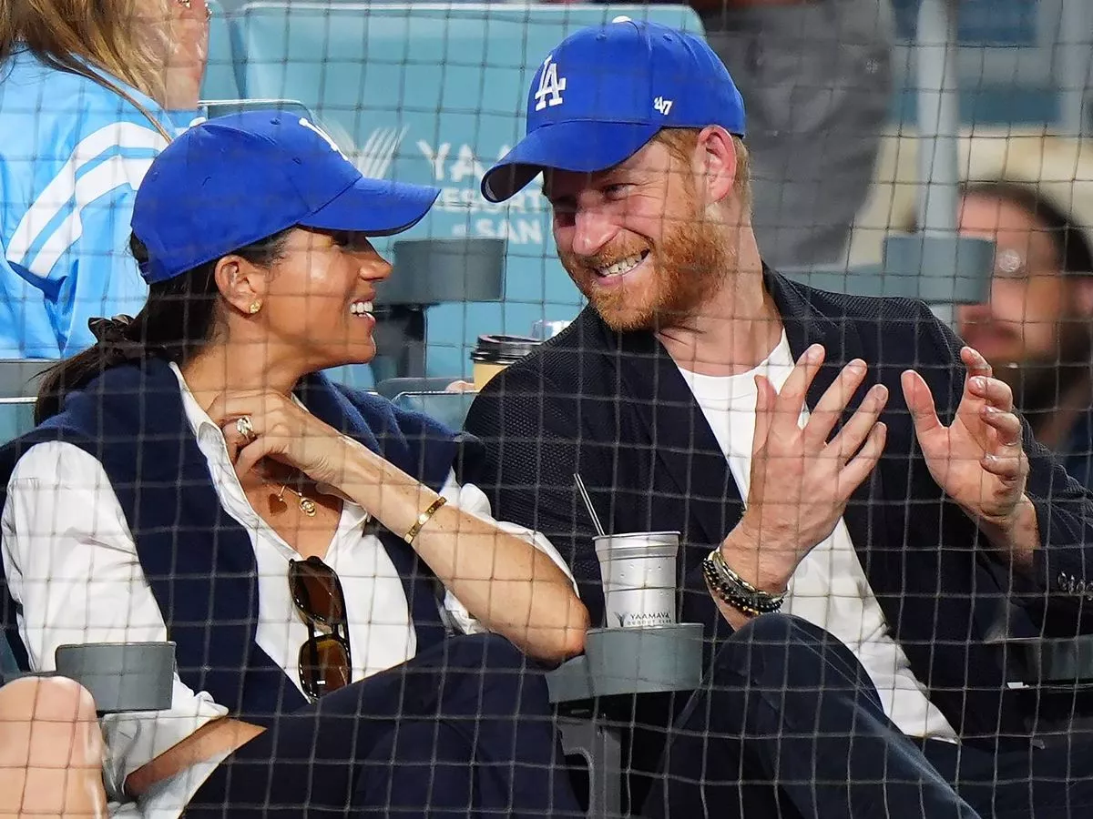 Prince Harry and Meghan Markle get royal treatment as they sit front row at LA Dodgers game