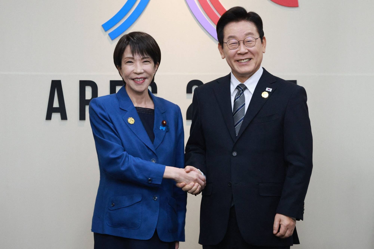 Japanese and South Korean leaders agree to boost ties in first meeting
