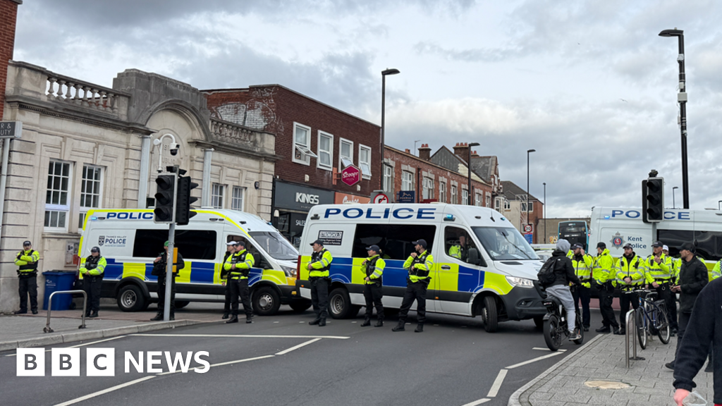Main road blocked as rival protests march through city