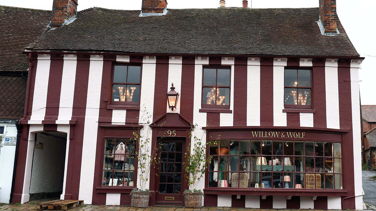 Boutique owner who painted 'Marmite' stripes on front of her Grade II listed shop could be forced to remove them after sparking uproar in affluent town