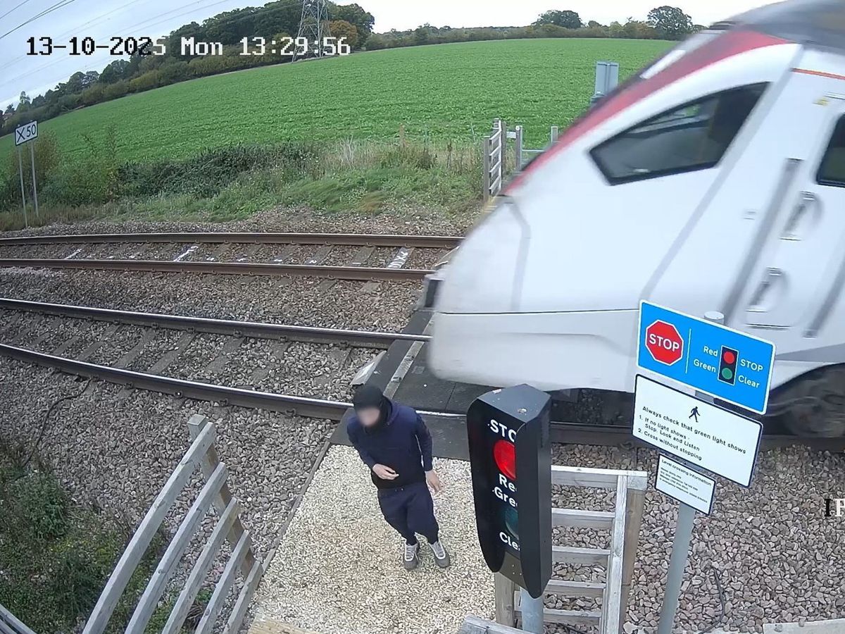 Shocking CCTV shows reckless teenager 'playing chicken' at level crossing