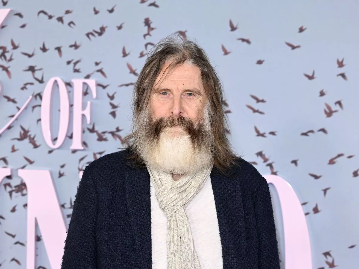 Can you name this British TV icon? Star sports bushy grey beard on red carpet