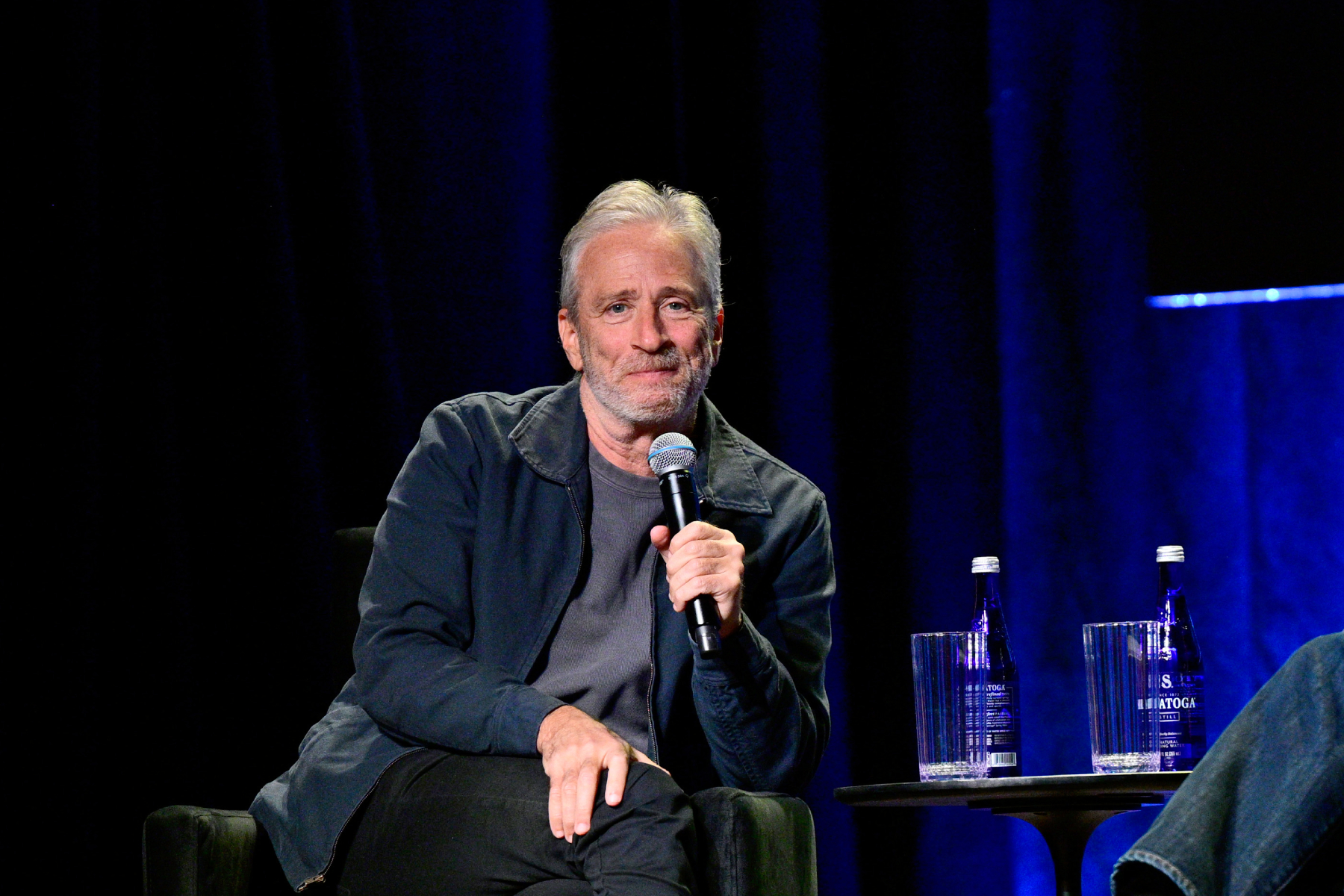 Jon Stewart Gives Update on Hosting ‘The Daily Show’: ‘We’re Working on Staying’