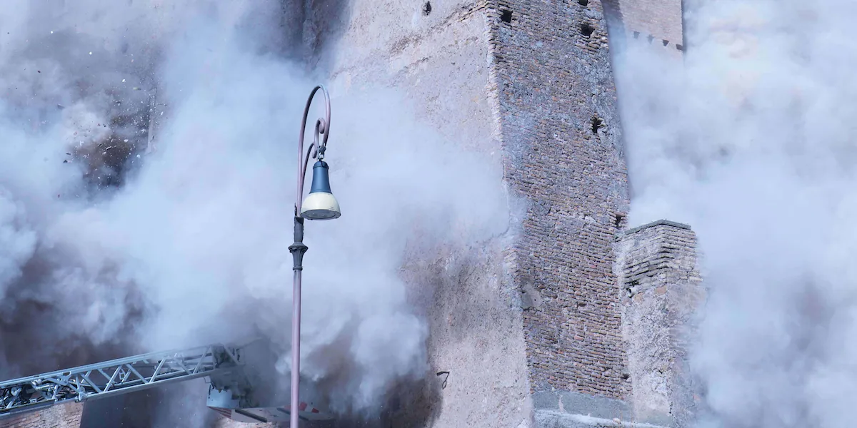 Medieval tower collapses, severely injuring a worker and trapping another