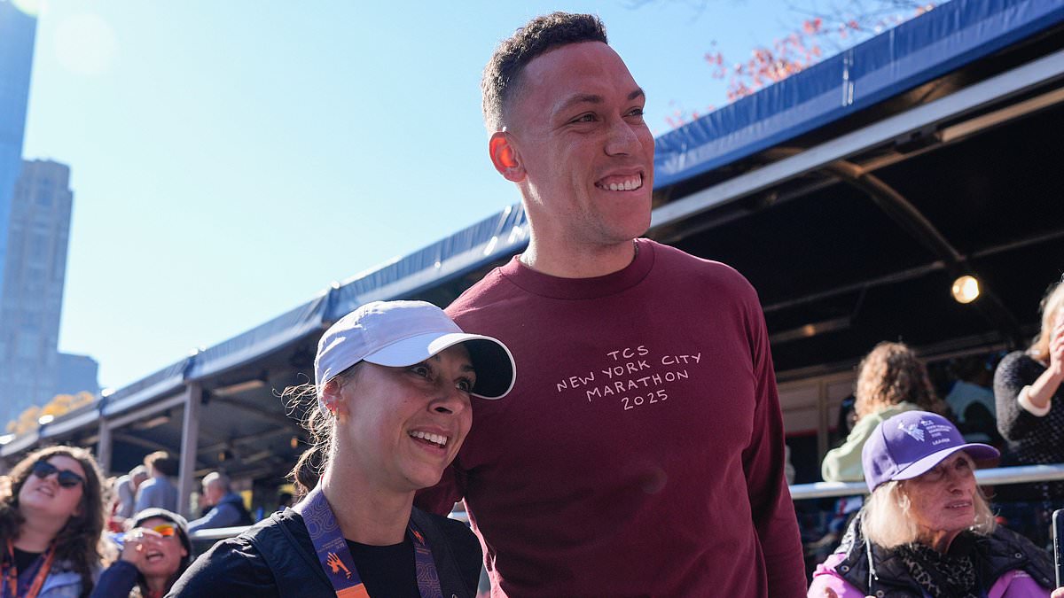 Yankees star Aaron Judge greets wife Samantha with a kiss after she finishes New York City Marathon