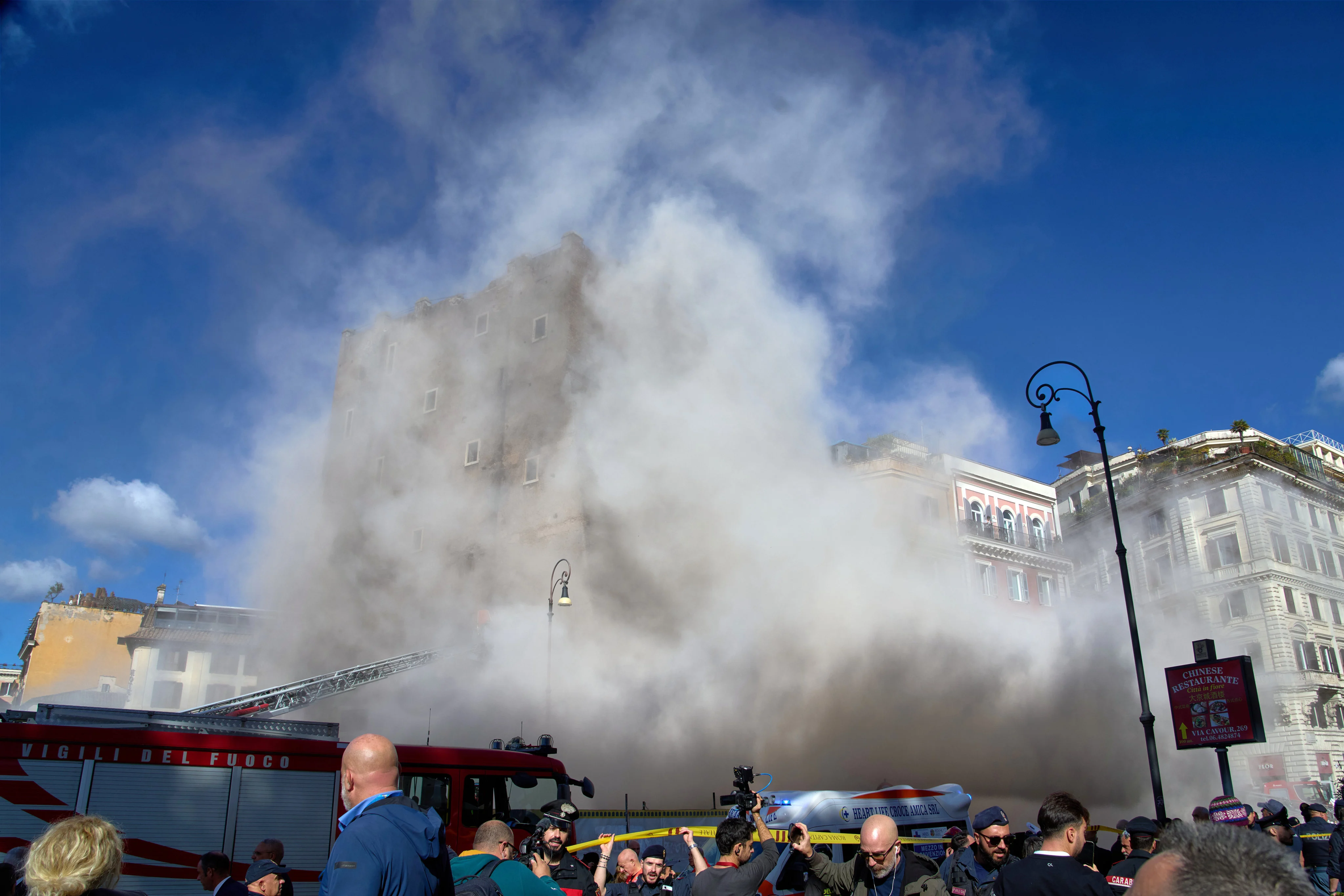 Rescuers in Rome try to reach a worker trapped in partially collapsed tower