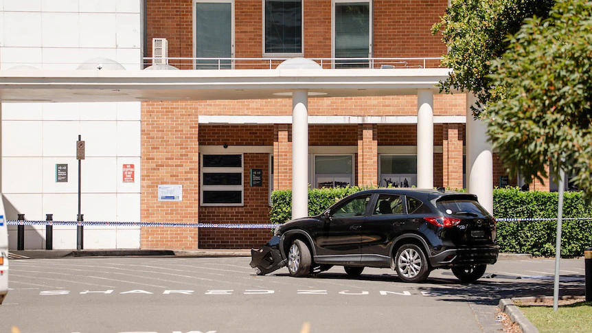 Workers fight for life after car runs them down outside Sydney hospital