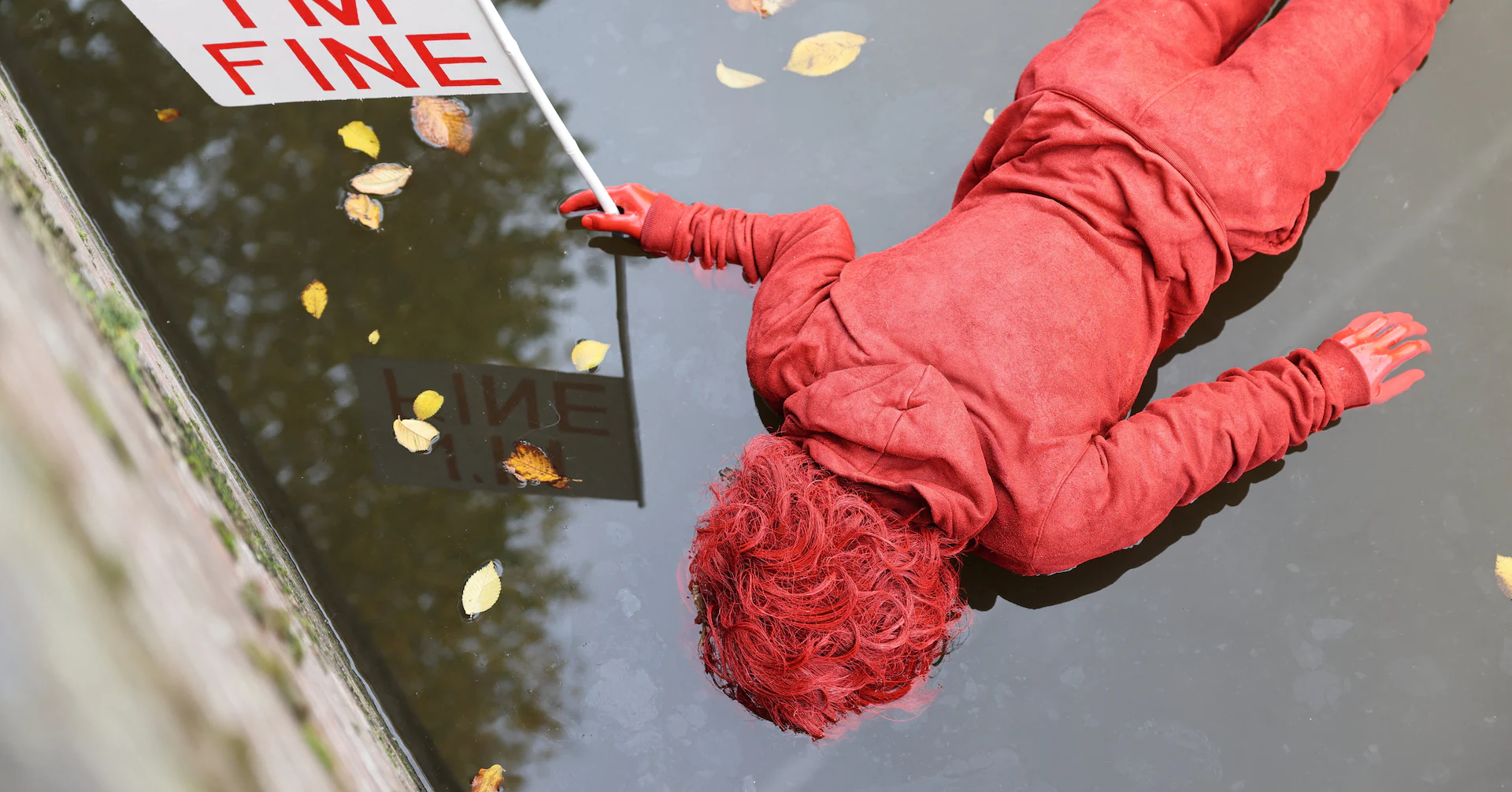 French artist's striking red figures in Amsterdam canals protest climate crisis