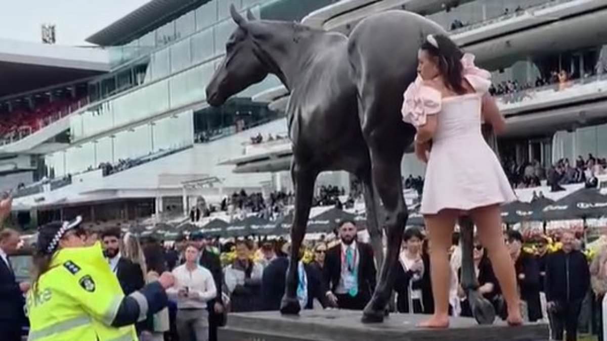 Is this 2025's 'Wheelie Bin girl'? Excruciating moment Melbourne Cup racegoer tries to ride a horse  statue- before getting told off by the police