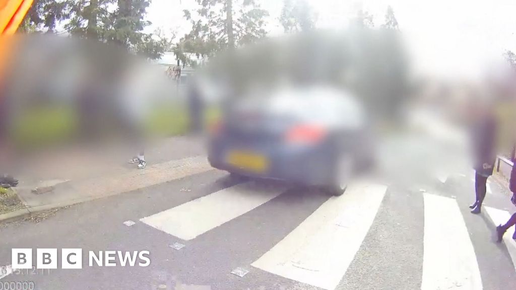 Watch: Car narrowly misses pupils and lollypop woman