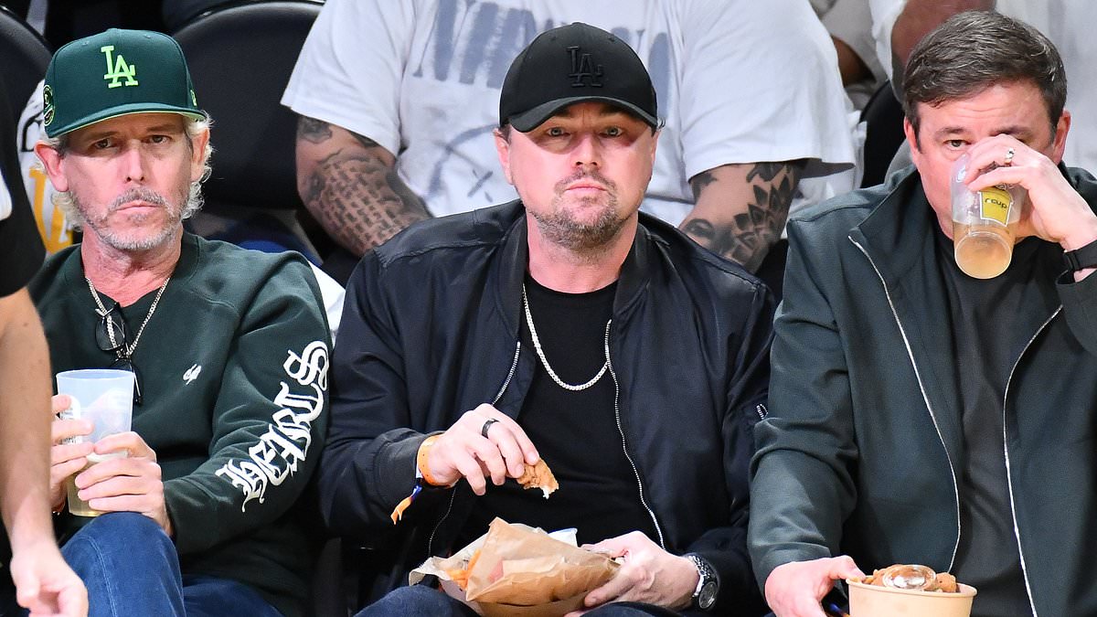 Leonardo DiCaprio tucks into chicken nuggets and soda during rare appearance without girlfriend Vittoria Ceretti as he enjoys a boys' night out at the Los Angeles Lakers