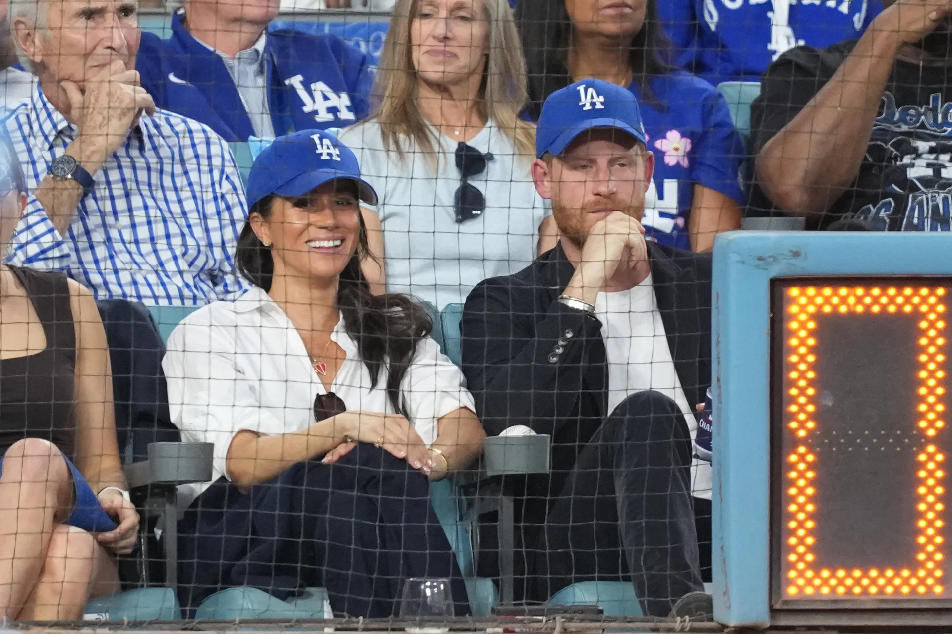 “Father is literally the King of Canada”; Traitors - Fans roll eyes as Prince Harry and wife Meghan sport Dodgers gear at World Series Game 4