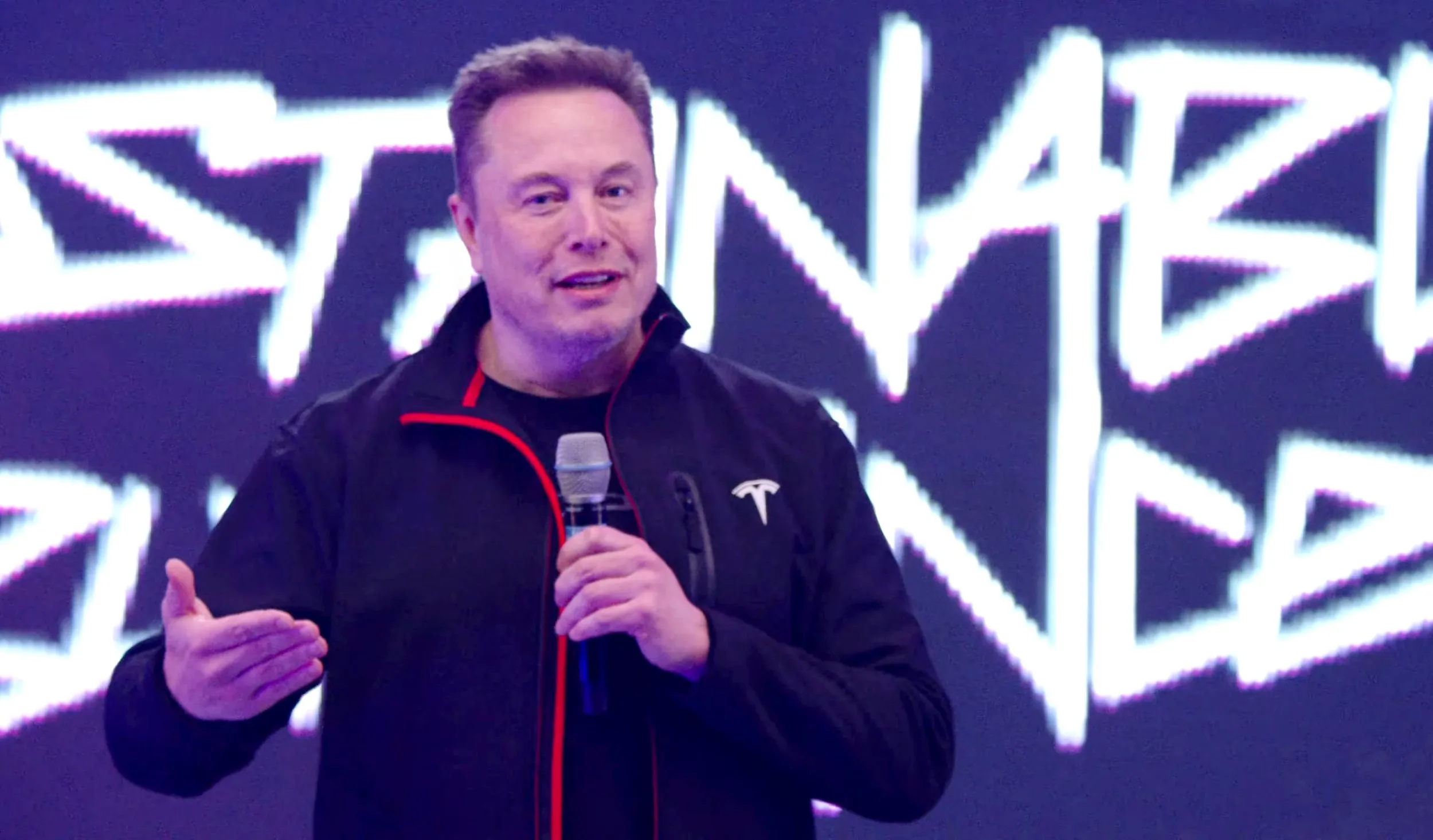 Musk does a jig on stage after agreeing deal that could net him $1,000,000,000,000